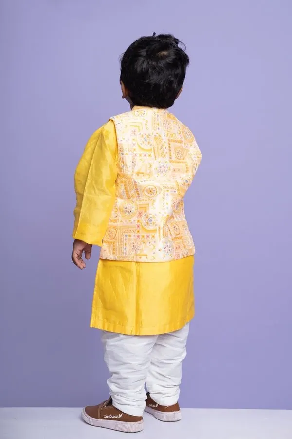 Vibrant yellow kurta set with an embroidered Peach Nehru jacket, paired with classic white churidar pants for a festive look